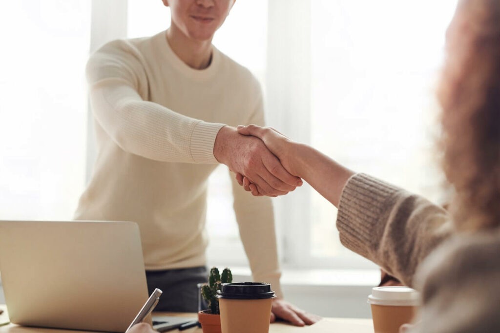 Employee shaking hand with a customer