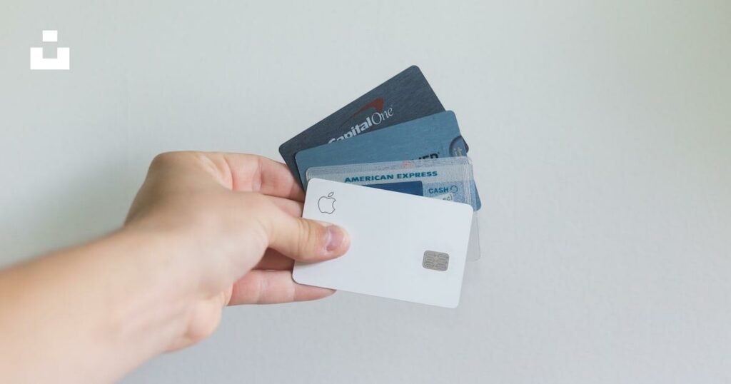 A hand holding multiple Credit cards