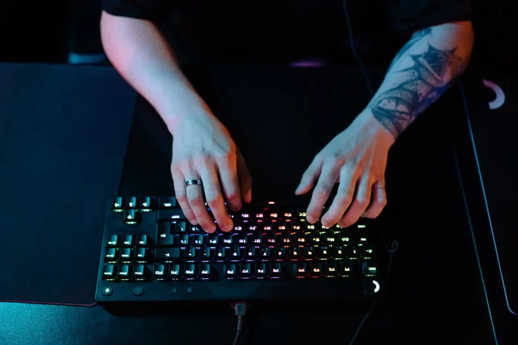 a person using an RGB gaming keyboard for Cloud Gaming
